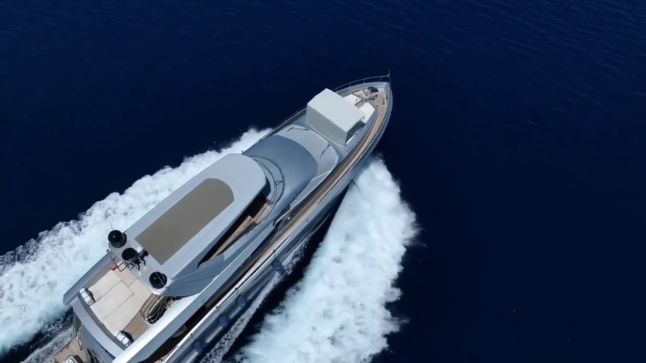 A white yacht gliding across deep blue water